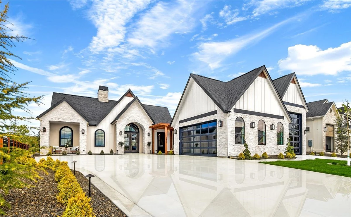 The Jane: white gables, stone entry and landscaped front approach