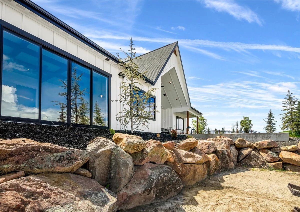 The Jane garden elevation, framed by stone landscaping and expansive windows
